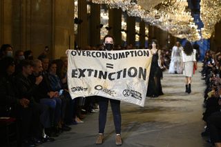 What is fast fashion: A woman protesting at fashion week