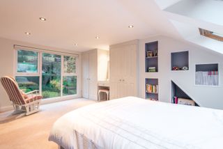 white loft conversion with custom built storage areas and windows