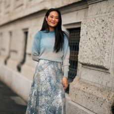 woman wearing a lightweight sweater and a sparkly skirt
