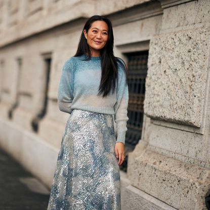 woman wearing a lightweight sweater and a sparkly skirt