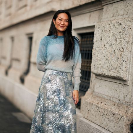woman wearing a lightweight sweater and a sparkly skirt