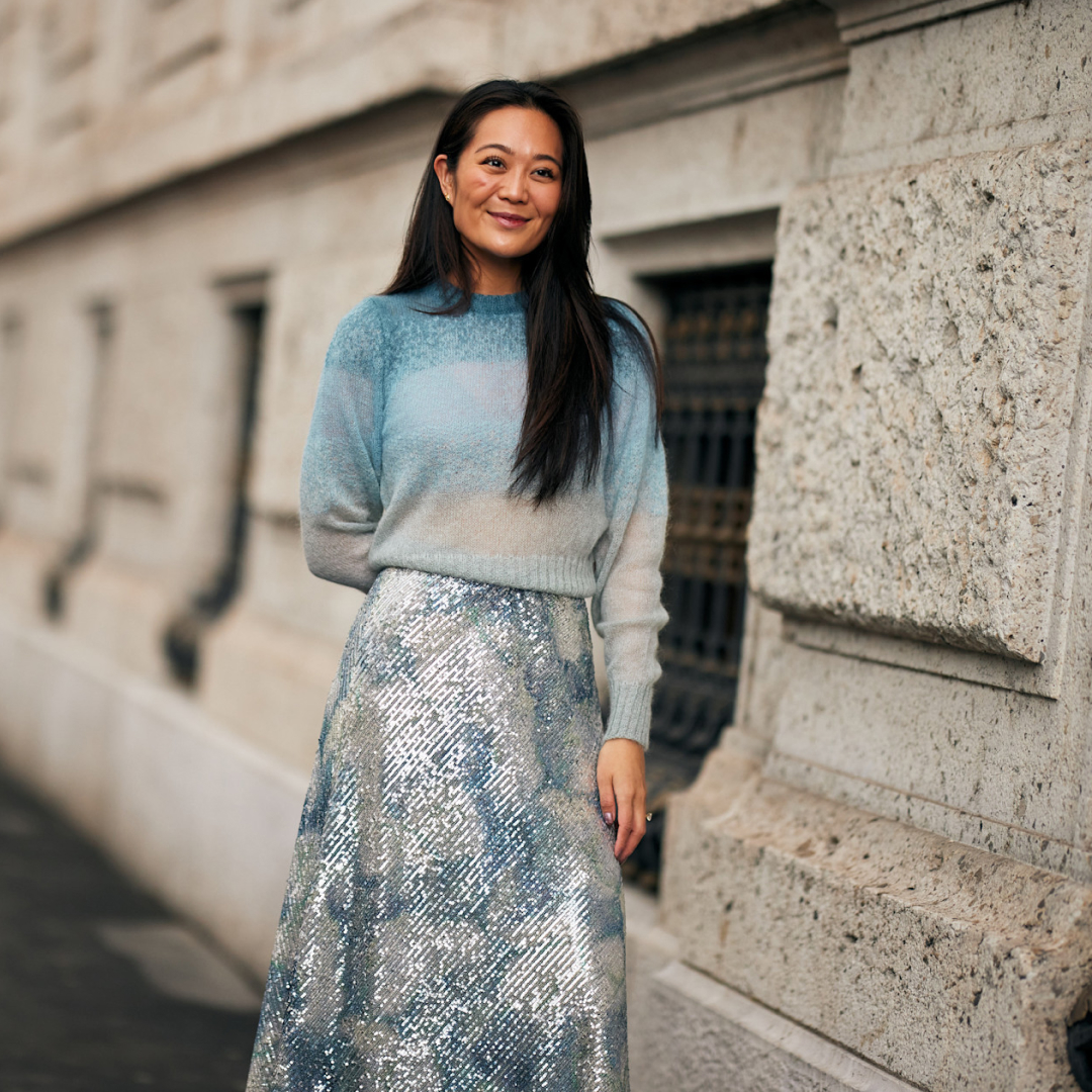 woman wearing a lightweight sweater and a sparkly skirt