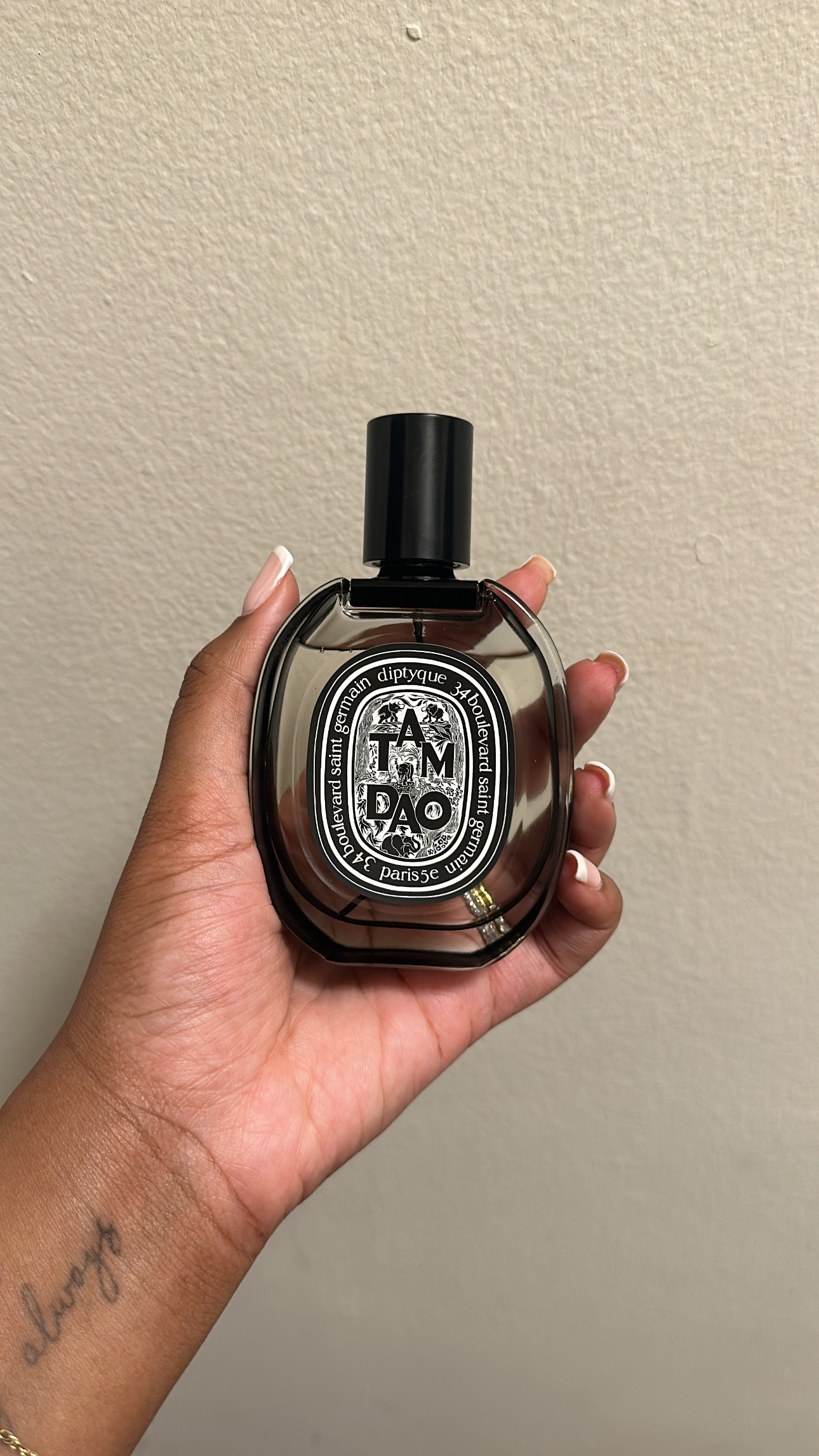 Ariel Baker testing Diptyque Tam Dao perfume.