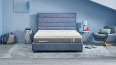 TEMPUR-Cloud Mattress on a blue bed base against blue walls.