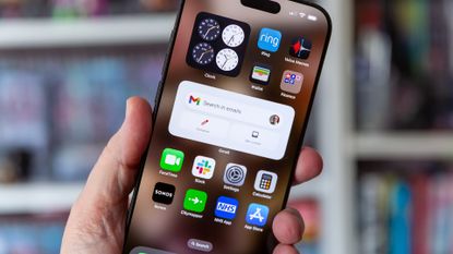 iPhone 16 Pro Max homescreen with iOS 18.5, held by man