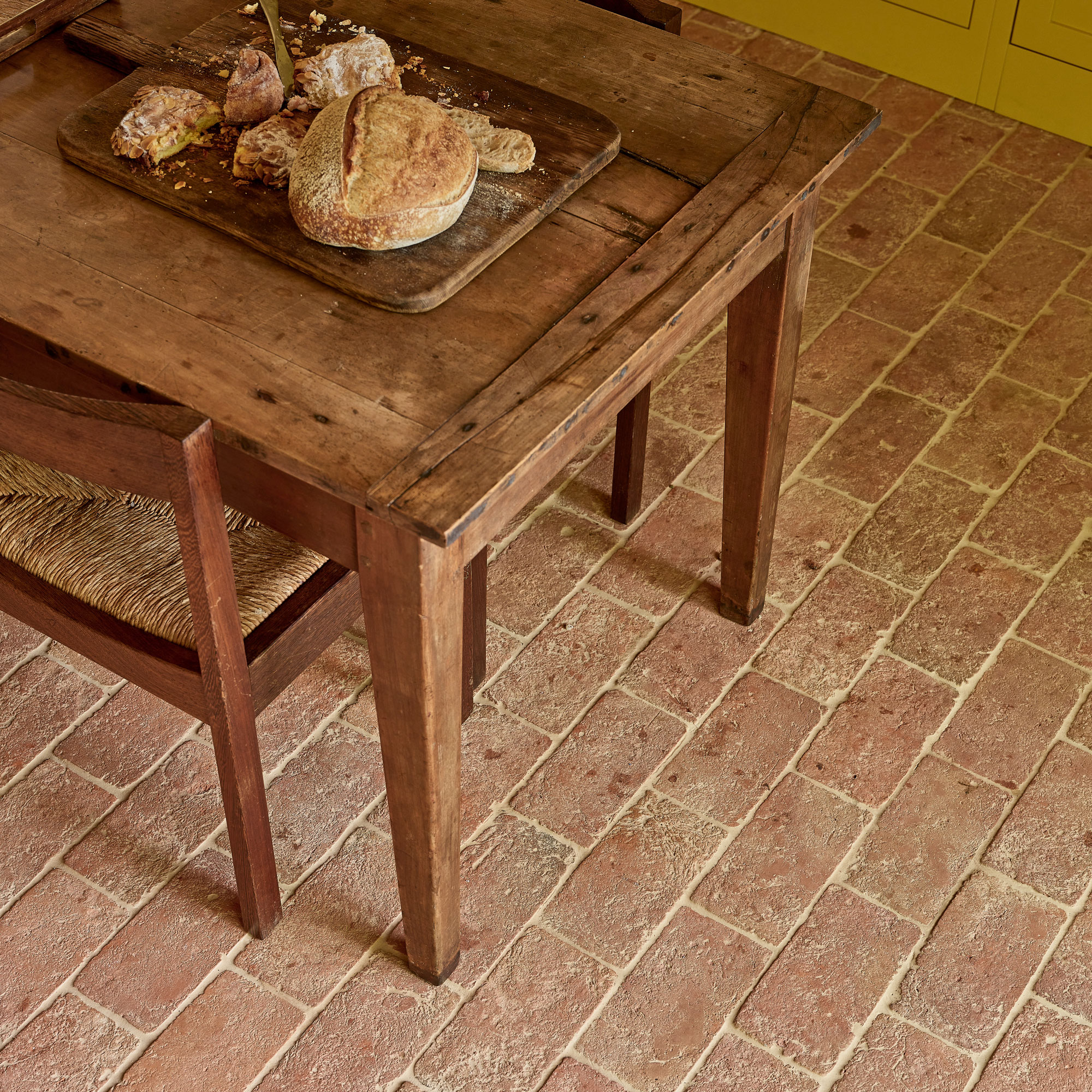 Terracotta floor tiles layed in a brick style format