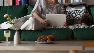 A woman holding the Google Pixel Tablet