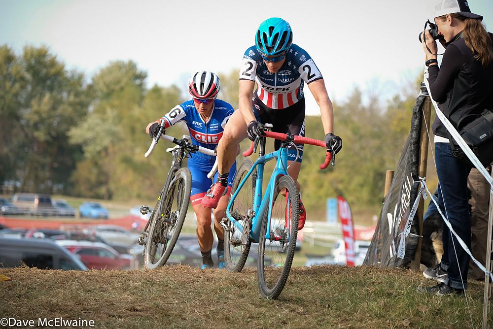 Katie Compton (Trek Panach) remounting her bike after a small set of stairs with Nash close behind