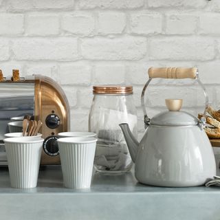 kitchen with white walls teapot and toaster