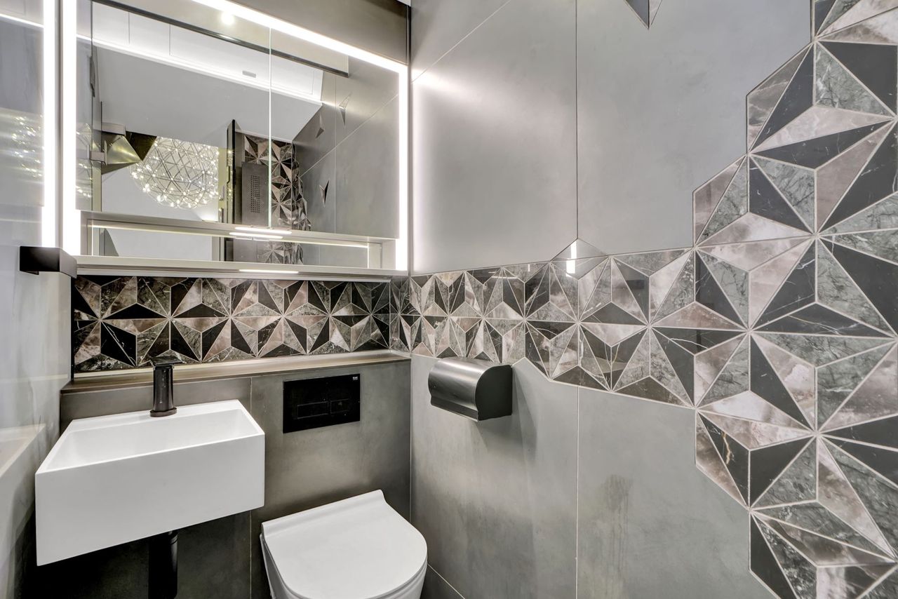 A bathroom with grey decor inside the small home