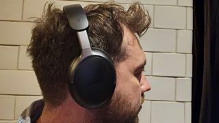 A person wears the Bose QuietComfort Ultra headphones