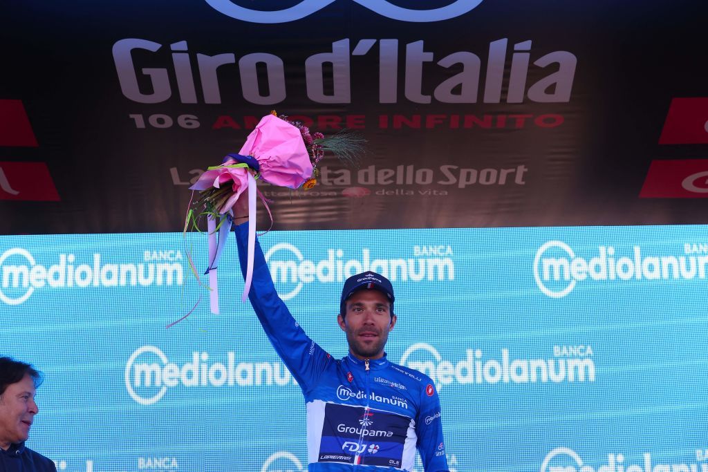 Groupama FDJs French rider Thibaut Pinot celebrates his best climbers blue jersey on the podium after the twentieth stage of the Giro dItalia 2023 cycling race a 186 km individual time trial between Tarvisio and Monte Lussari on May 27 2023 Photo by Luca Bettini AFP Photo by LUCA BETTINIAFP via Getty Images