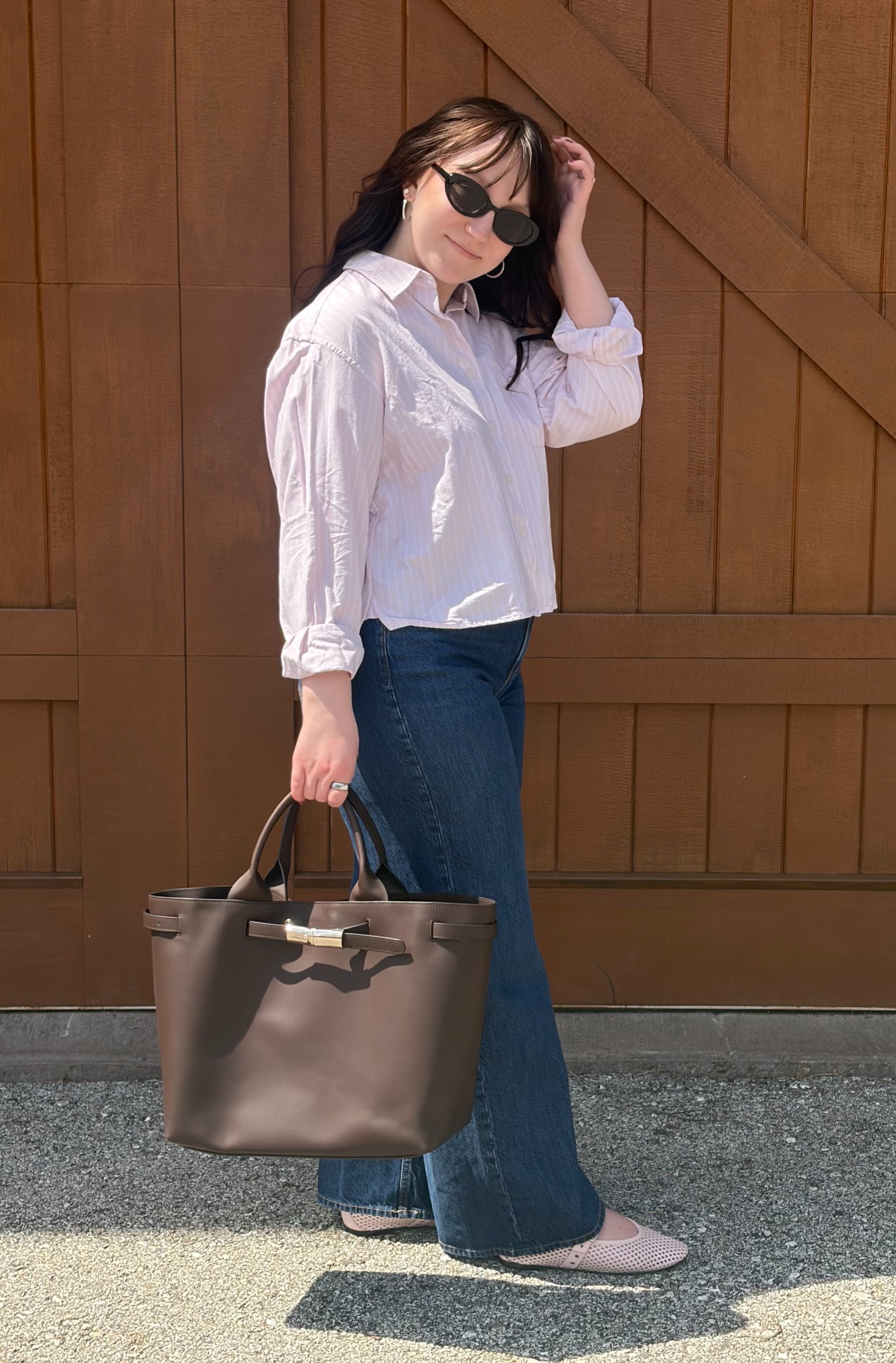 Meguire Hennes carrying Longchamp's Le Roseau Smart Large Leather Tote
