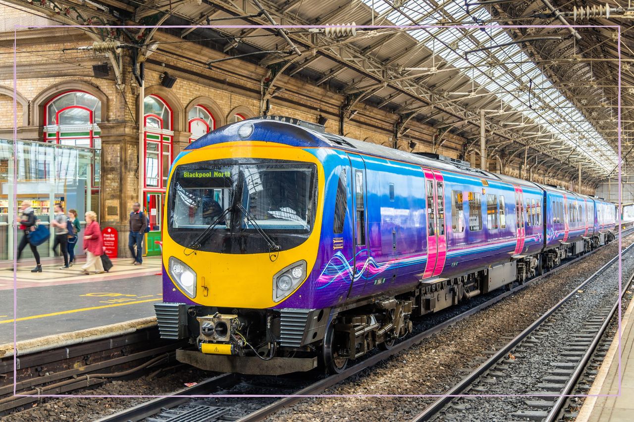 A train waiting at a platform in Preston train station