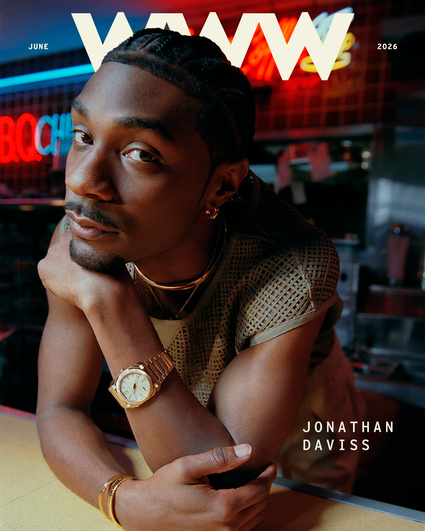 Jonathan Daviss wears a short-sleeve shirt and a gold watch.