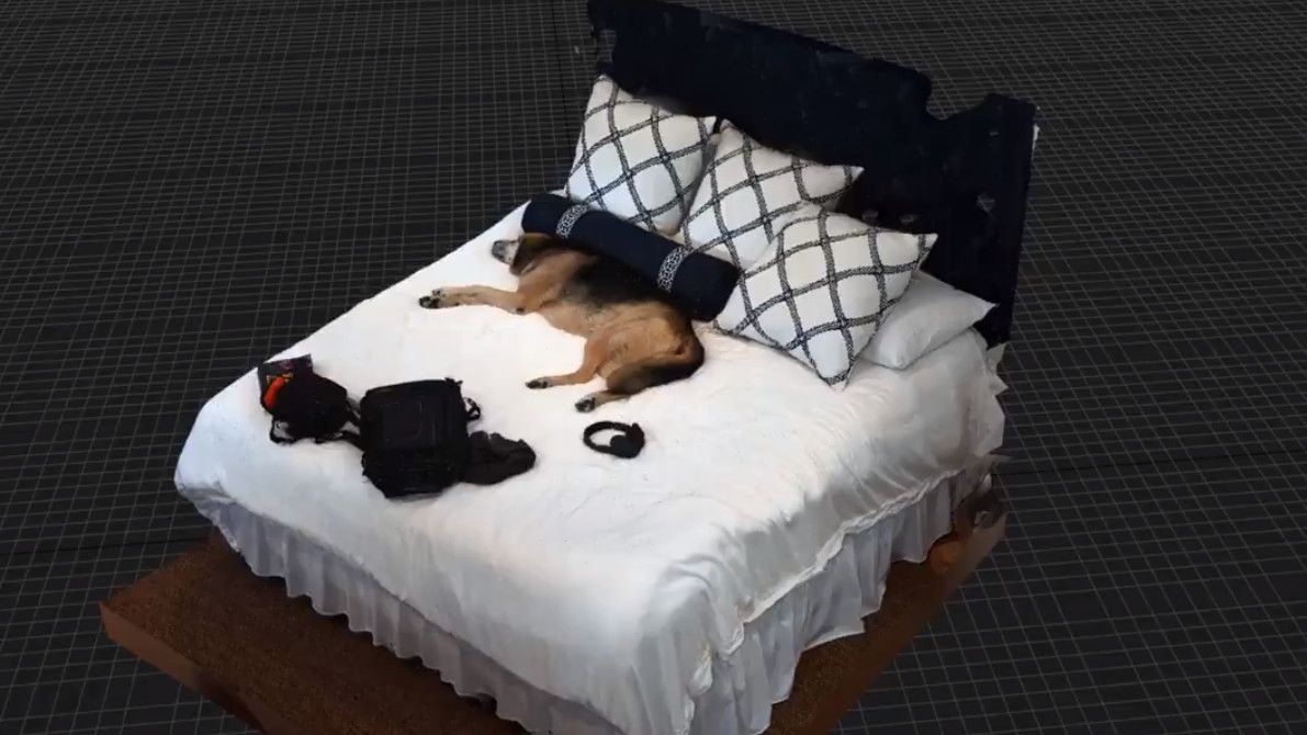 A dog, on a bed, inside Unreal Engine 5.