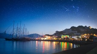 The night sky over a harbor, with stars visible
