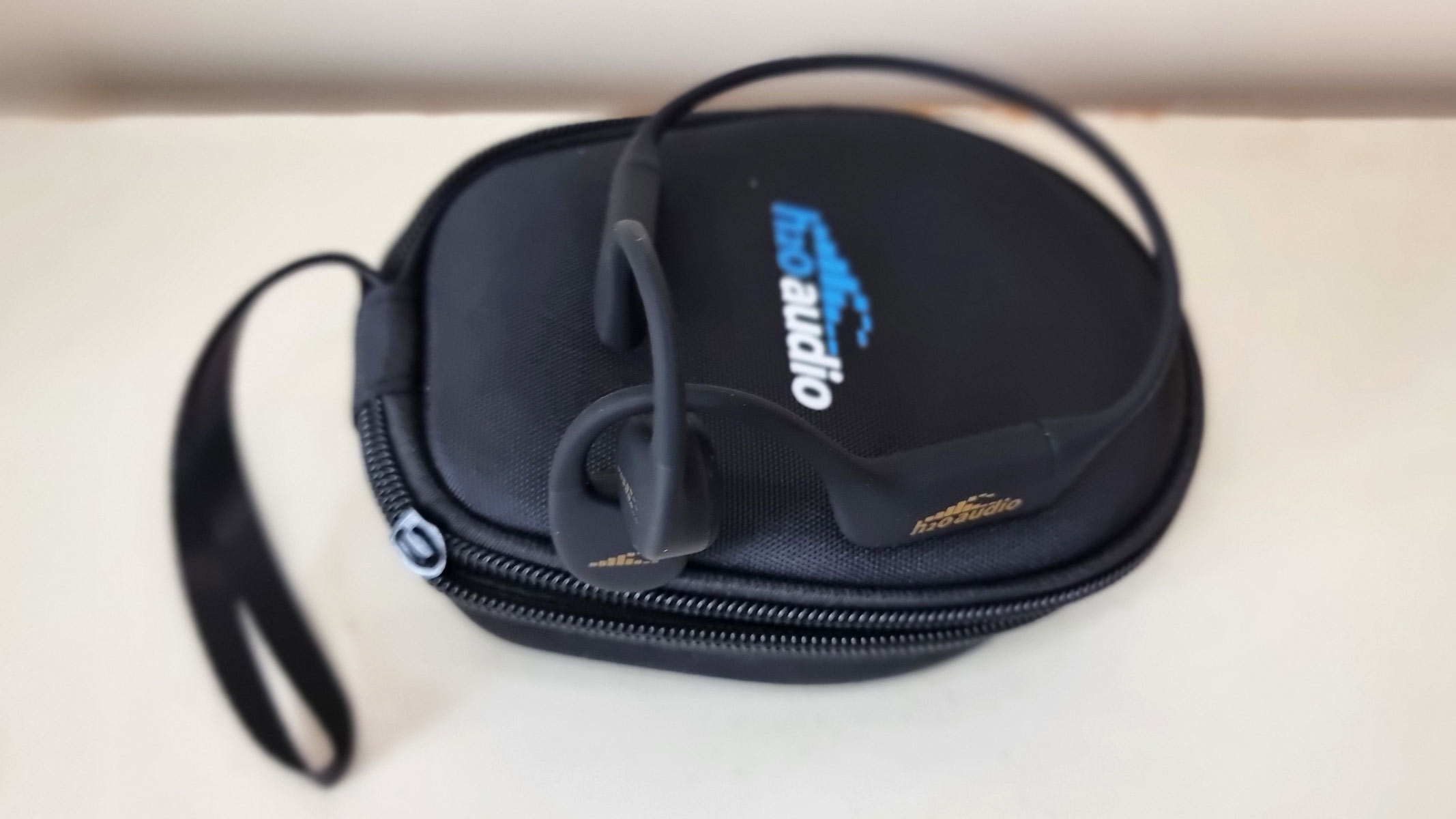 a picture of the H20 Audio Tri 2 Pro bone conduction headphones on top of a carrying case