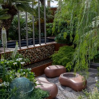 Small garden with copper pebble shaped seats