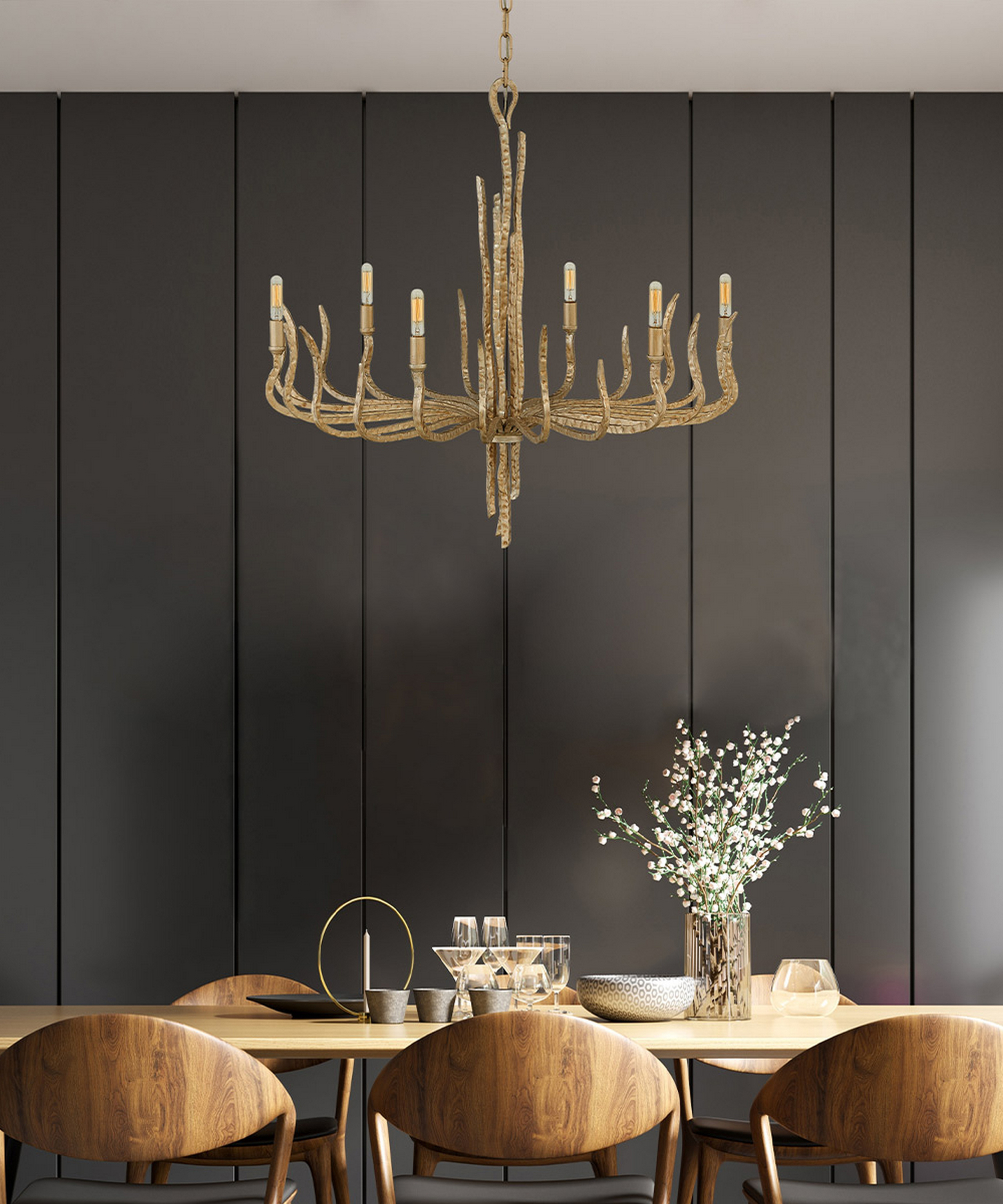 dining room with large modern chandelier, table and chairs and dark grey wood panelled wall