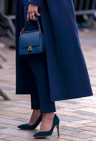 he handbag and shoes worn by Britain's Catherine, Duchess of Cambridge are seen as she chats with well-wishers, during a visit to the University of Glasgow in Scotland on May 11, 2022, where she talks with students about mental health and wellbeing.
