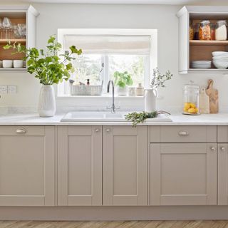 White kitchen sink above Cashmere units in a Shaker-style kitchen