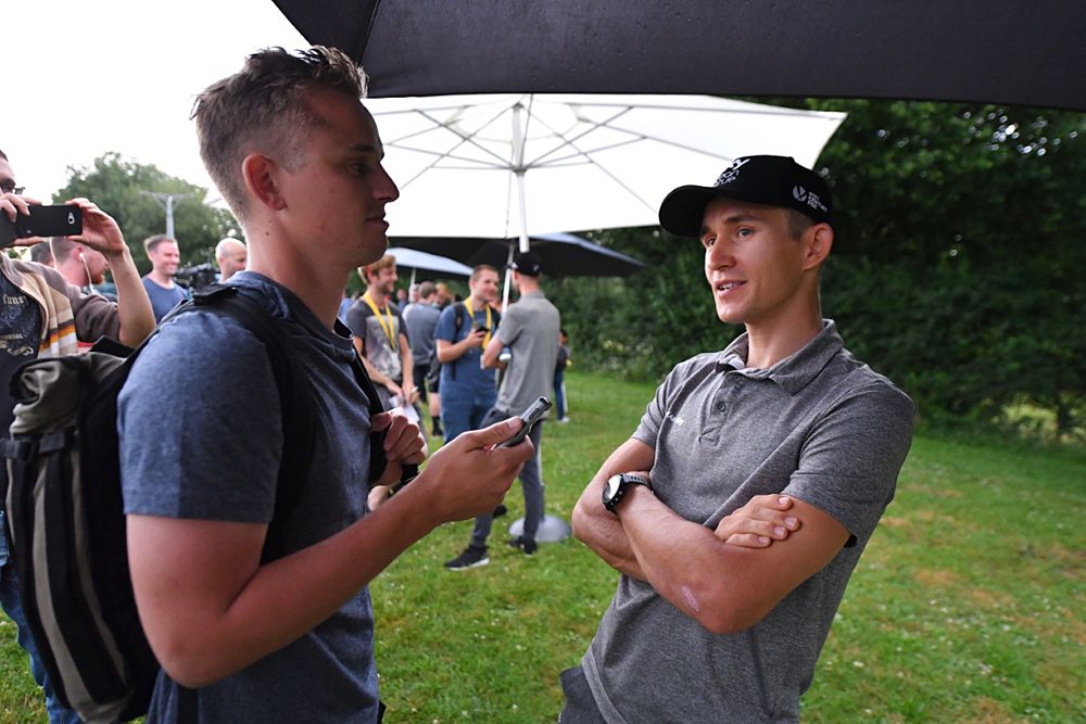 Team Sky riders chat at an outdoor press conference at the Tour de France