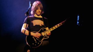 Snowy White playing guitar with Pink Floyd on the Animals tour in the 1970s wearing a pig T-shirt