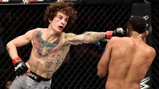 Sean O'Malley punches Terrion Ware in their bantamweight bout ahead of O'Malley's headline fight at UFC 292 on Sat, Aug 19.