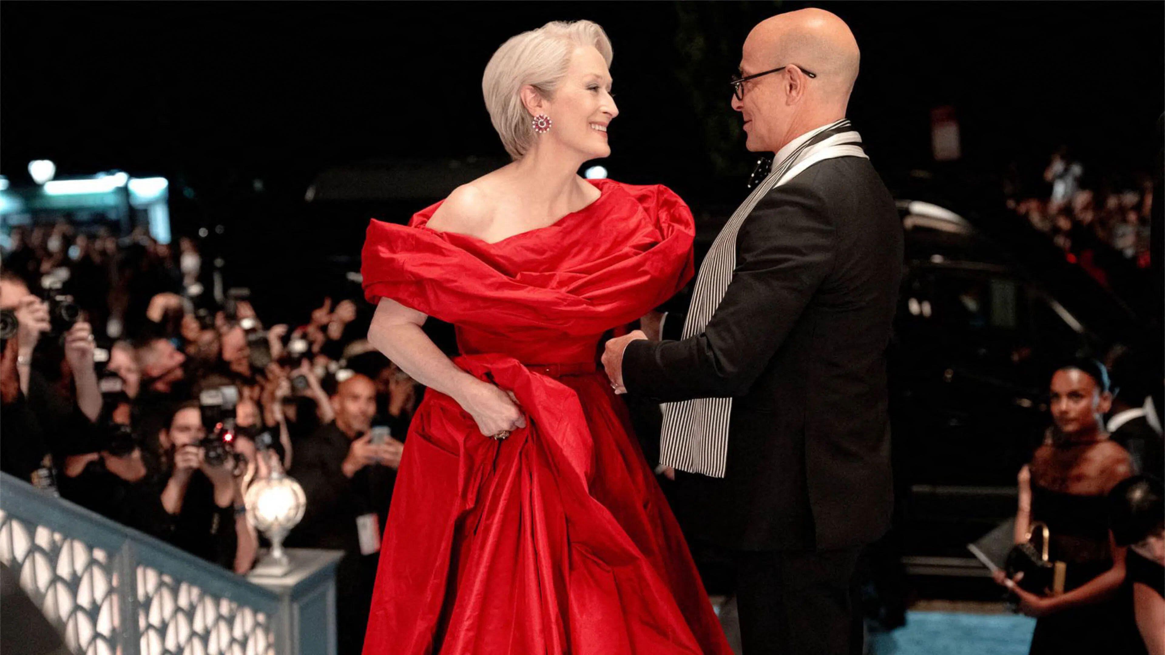 L-R: Miranda (Meryl Streep) and Nigel (Stanley Tucci) stand near paparazzi in a scene from "The Devil Wears Prada 2"