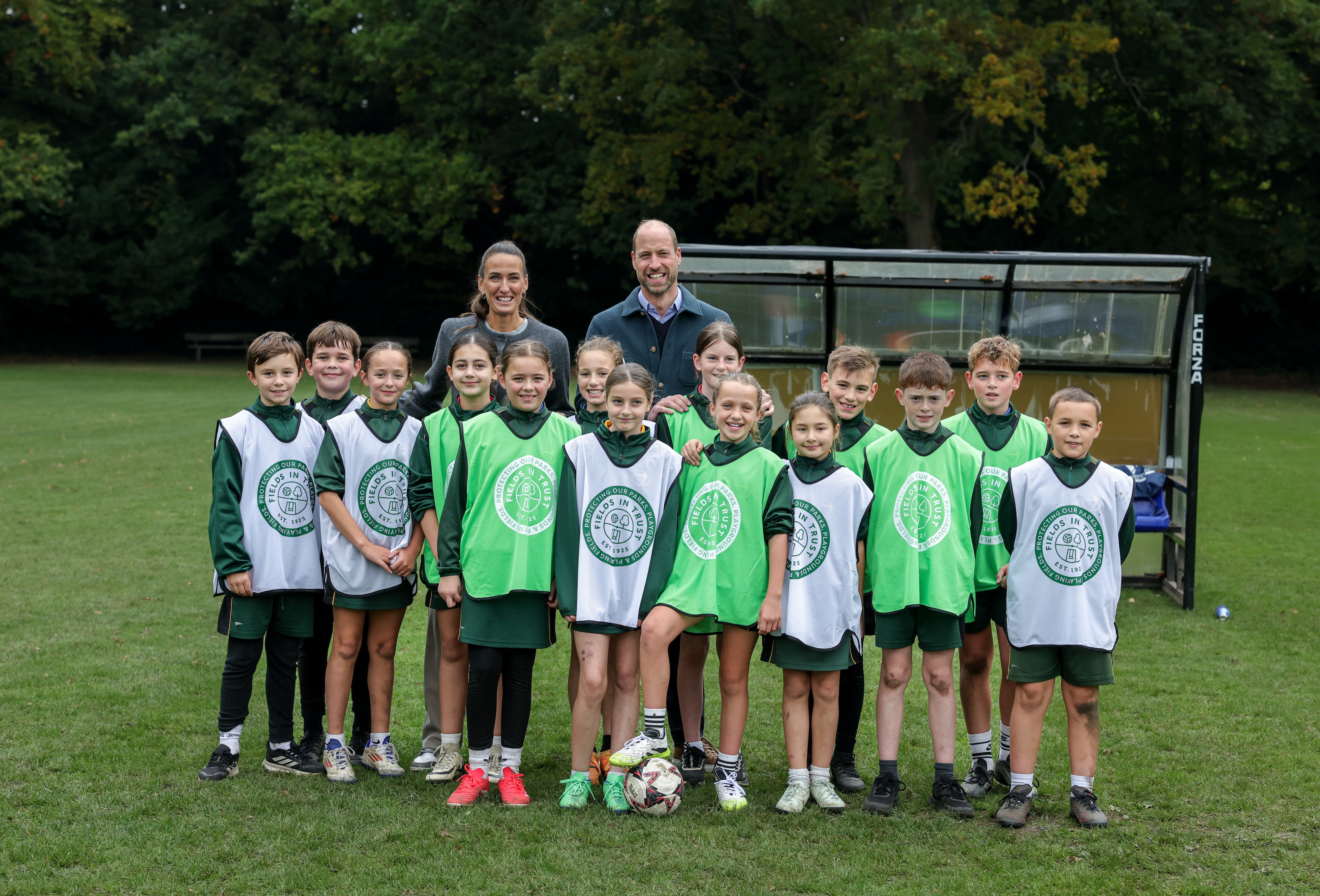 Prince William and Jill Scott posing with young soccer players