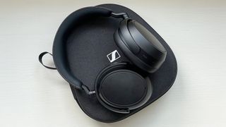 Listing image for best noise-cancelling headphones showing Sennheiser Momentum 4 Wireless headphones with case