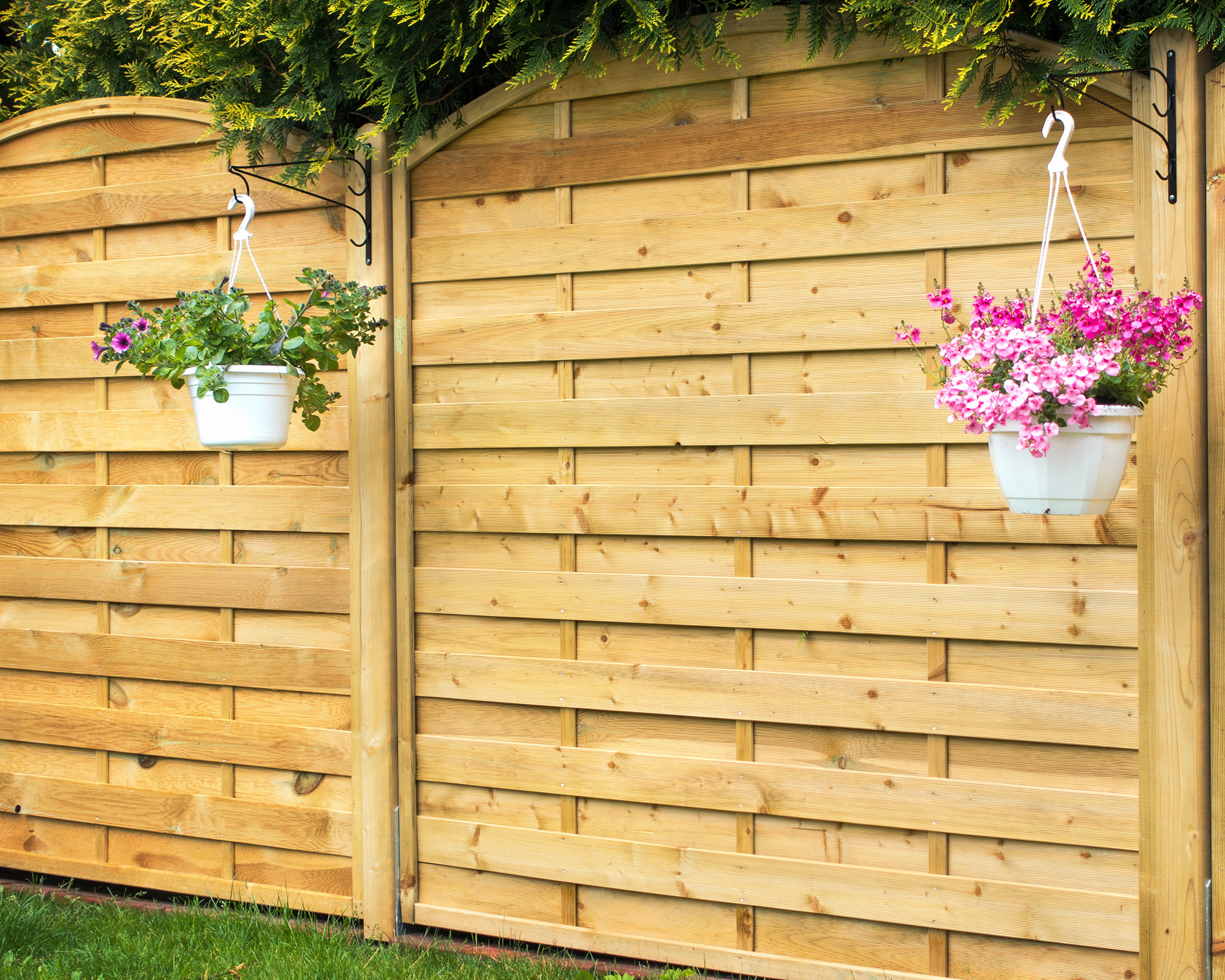 New wooden fence panel with hanging baskets