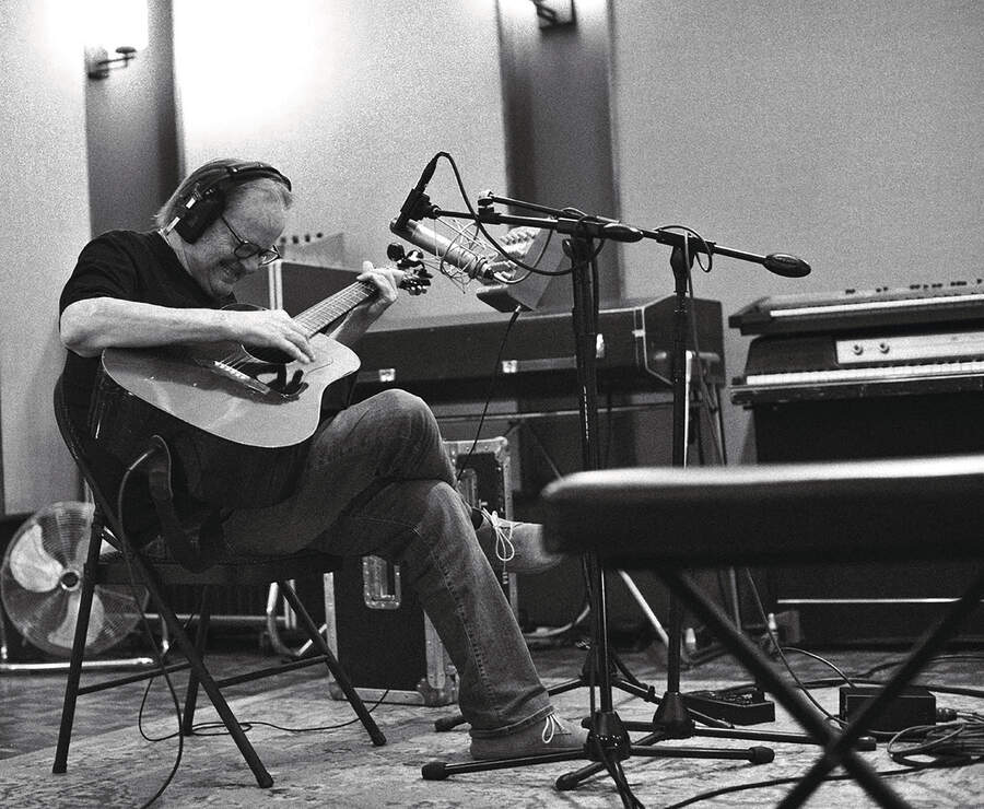 Water Trout playing acoustic guitar in the studio