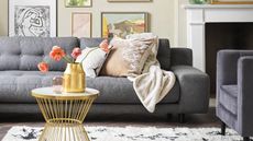 Niksen-friendly style - Habitat grey sofa in living room with picture frames all over rear wall