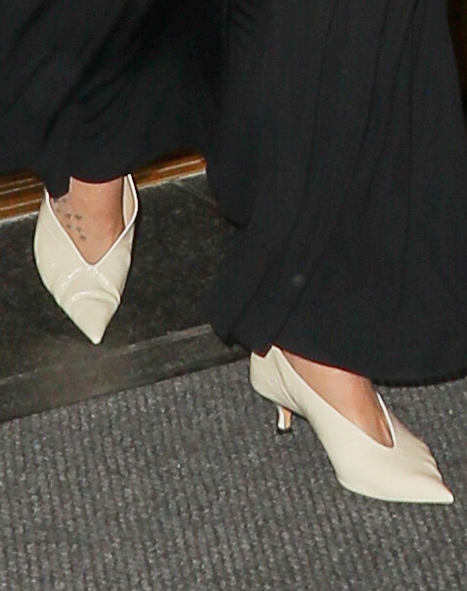 Dakota Johnson wearing cream pointed-toe glove pumps in NYC