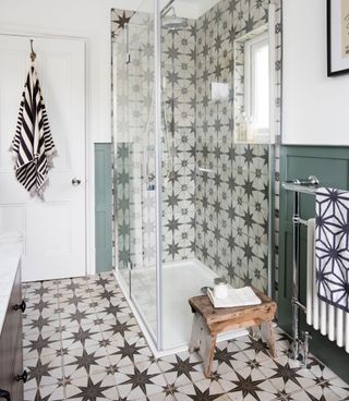 bathroom with towel and patterned tiles