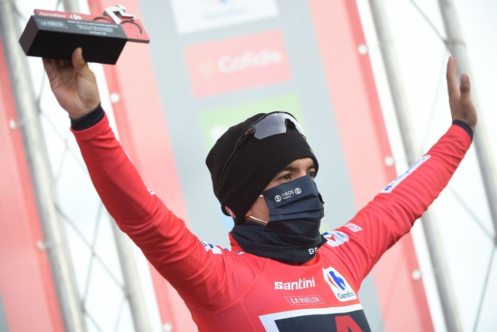 Team Ineos Ecuadorian rider Richard Carapaz celebrates on the podium with the overall leaders red jersey after the 12th stage of the 2020 La Vuelta cycling tour of Spain a 1094km race from Pola de Laviana to Alto de lAngliru on November 1 2020 Photo by MIGUEL RIOPA AFP Photo by MIGUEL RIOPAAFP via Getty Images