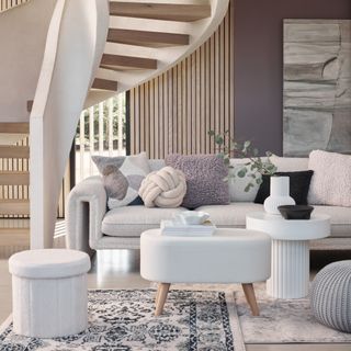 White neutral living room with cushions, white sofa, white coffee table