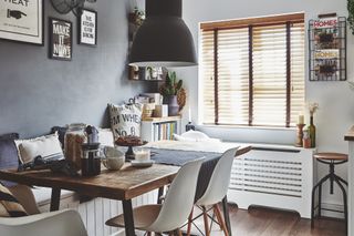 Dining set with Eames-style chairs in an open-plan Scandi-style kitchen diner