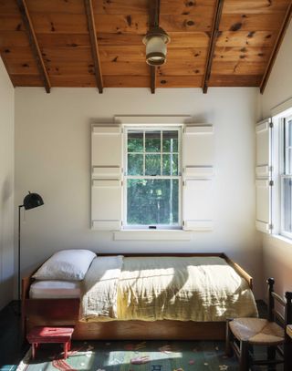 coastal farmhouse bedroom with wooden ceilings