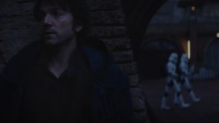 Cassian Andor, played by Diego Luna, hiding from a pair of stormtroopers