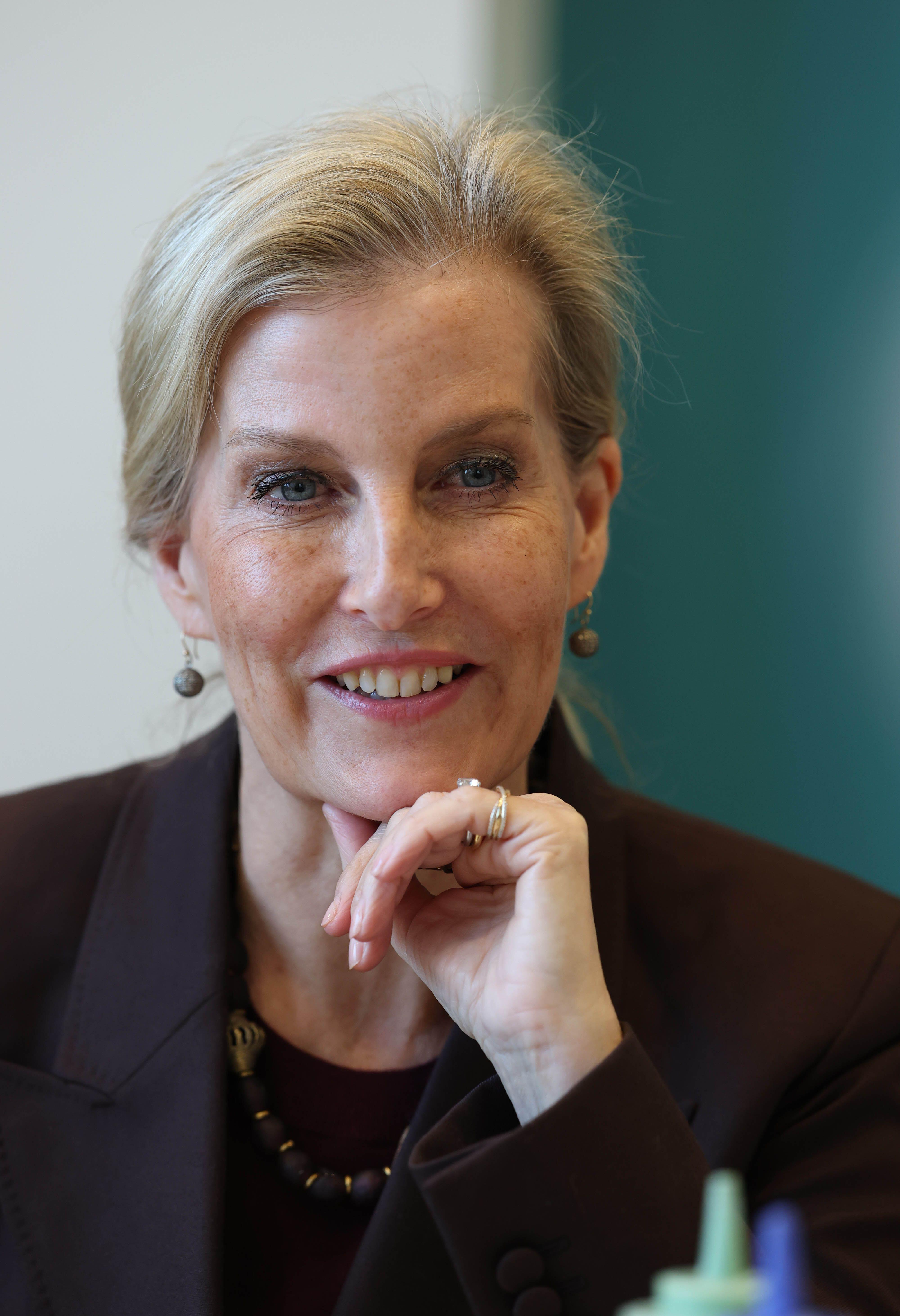 Duchess Sophie wearing a brown blazer resting her hand on her chin