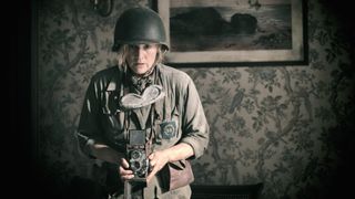 Kate Winslet as war photographer Lee Miller, wearing military uniform and holding a camera