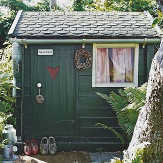 dark green shed in garden