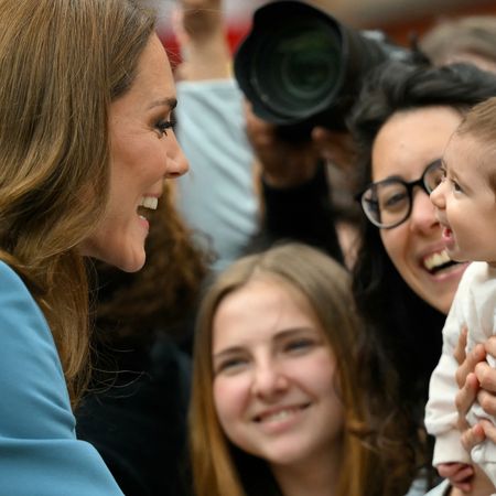 Princess Kate smiling at a baby