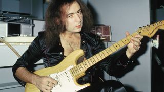 Ritchie BLACKMORE; Guitarist with Deep Purple, posed, backstage, playing Fender Stratocaster guitar