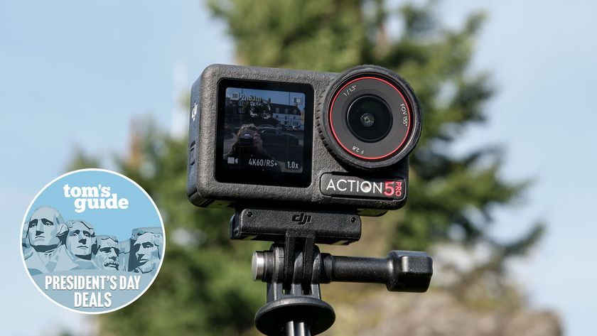 DJI Osmo Action 5 Pro on a selfie stick against a blue sky with a TG presidents' day badge in the bottom left of the image
