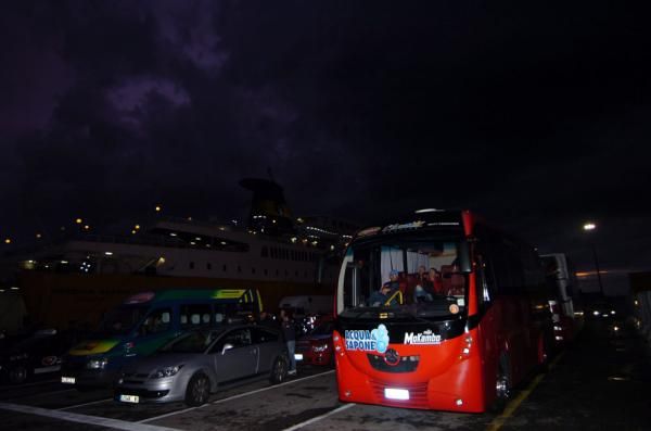The less-glamourous side of professional cycling: Aqua &amp; Sapone staff wait for late-night loading of the team vehicles on the Italian mainland