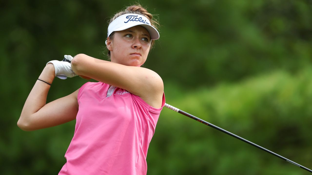 Anna Davis holds her finish after hitting a drive